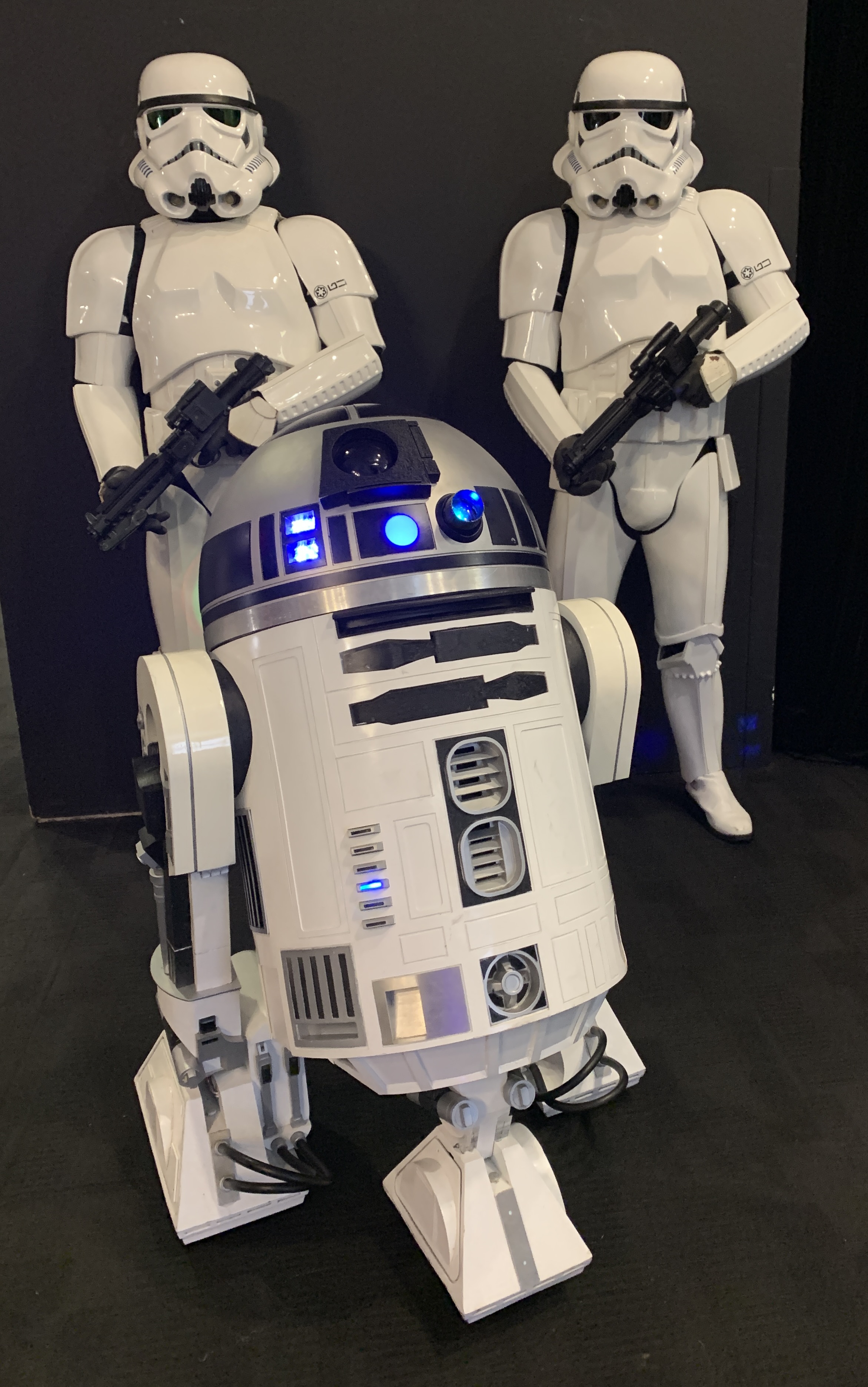 R2-TK with two Stormtroopers at the BFI Southbank ILM screening, his dome lights illuminated against a black backdrop.
